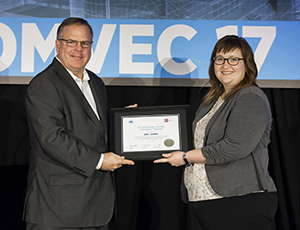 SAE/AEM Outstanding Young Engineer award winner Amy Jones receives plaque from SAE Board of Directors member Landon Sproull of PACCAR Inc. at 2017 SAE COMVEC Awards Luncheon.