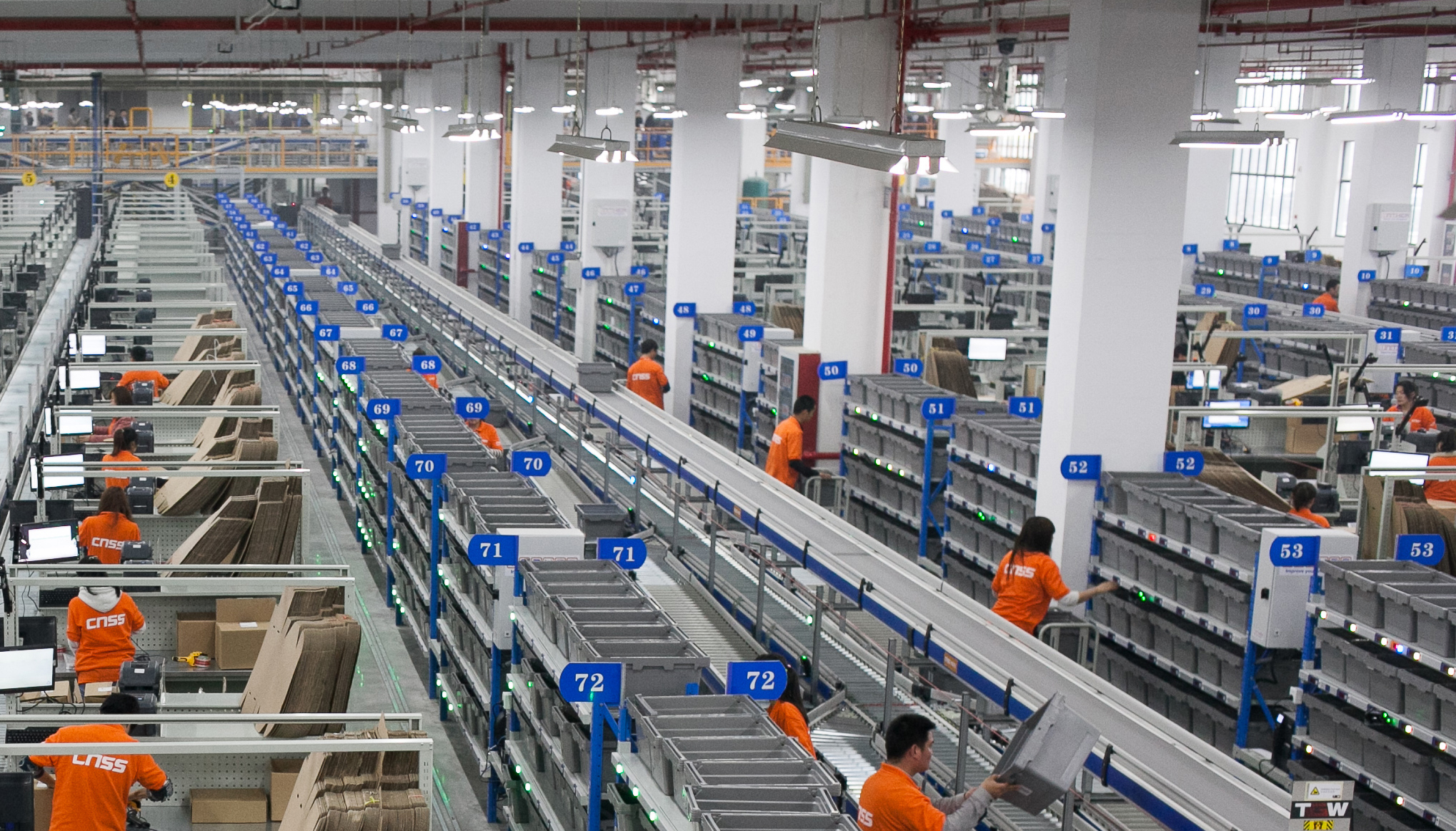 Shown here is 7.5 kilometers of conveyors at a distribution-center-for-hire in Danyang, China. Owned by e-commerce company CNSS, the automated center sorts and ships up to 7,500 packages per hour. Designed by TGW Logistics Group, it includes TGW conveyors that automatically feed shelves, channelizers and sorters. Online orders trigger commands to tell workers to put goods in totes on the conveyors. Scanners automatically confirm tote contents. Then the totes ride down to a picker for boxing and shipment. The biggest sorter is 100 meters long with 30 chutes.