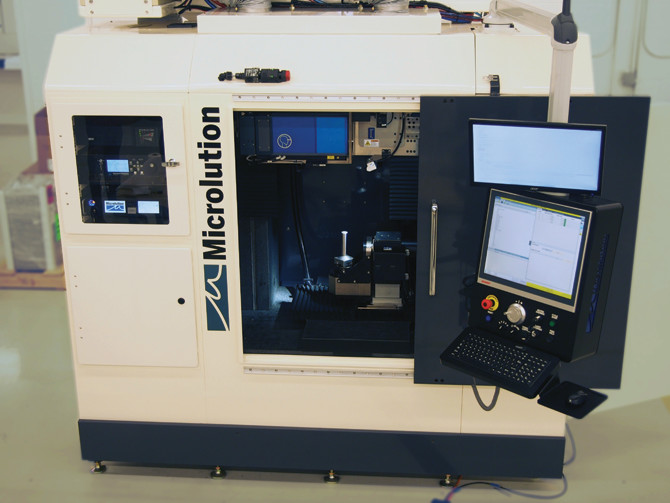 The interior view of a Microlution machining center shows the custom rotary table and the user interface and control center. 